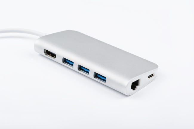 An aluminum, multi-port adapter on white background.